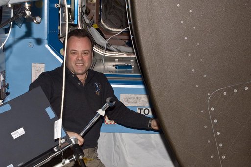 Expedition 28 FE Garan poses for a photo in the US Lab