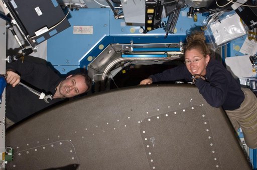 Expedition 28 FE Garan and STS-135 MS Magnus pose for a photo in the US Lab