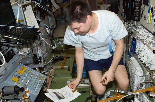 Kononenko reads a procedures checklist in the SM