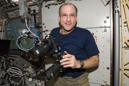 Pettit works with two still cameras mounted together in the U.S. Laboratory
