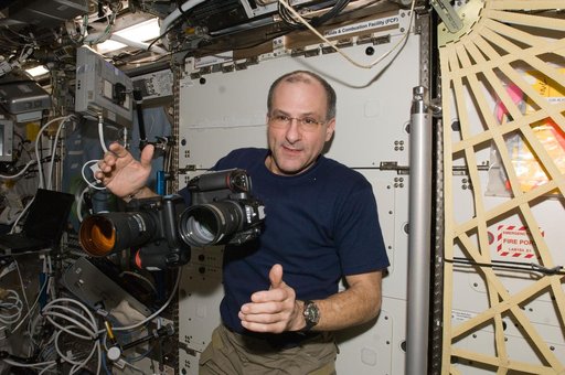 Pettit works with two still cameras mounted together in the U.S. Laboratory