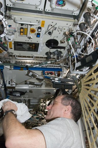 Pettit performs an in-flight maintenenace on the PWD in the U.S. Laboratory