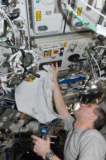 Pettit performs an in-flight maintenenace on the PWD in the U.S. Laboratory