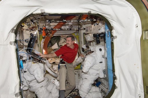 Burbank performs routine in-flight maintenance on the EMU