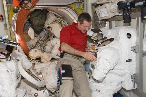 Burbank performs routine in-flight maintenance on the EMU