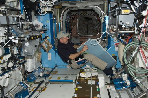 Burbank performs maintenance on the light cover for the MSG