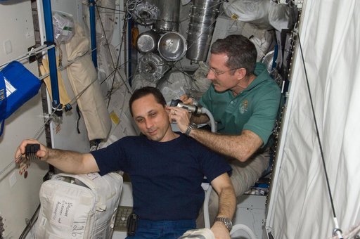 Burbank trims Shkaplerov's hair in the Node 3