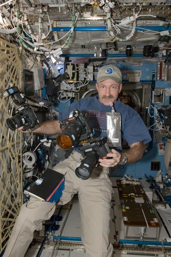 Burbank holds cameras in the U.S. Laboratory
