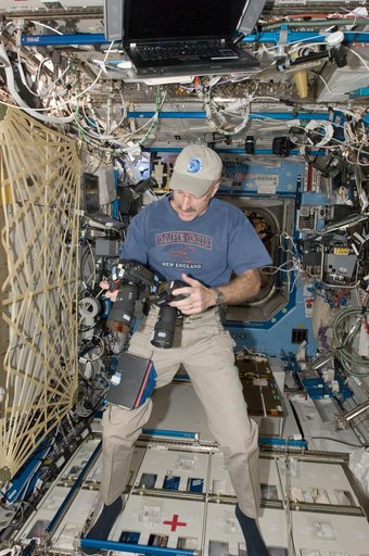 Burbank holds cameras in the U.S. Laboratory