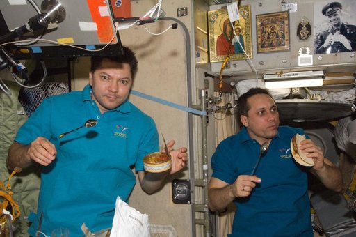 Kononenko and Shkaplerov enjoy a meal in the SM
