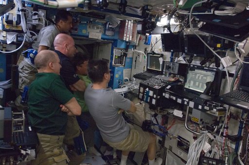 Crewmembers watch Dragon Launch on Computer Screen