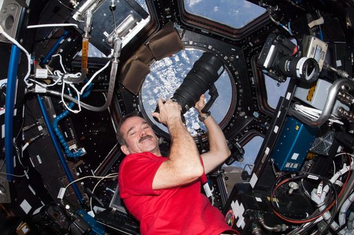 Hadfield uses still camera in the Cupola Module