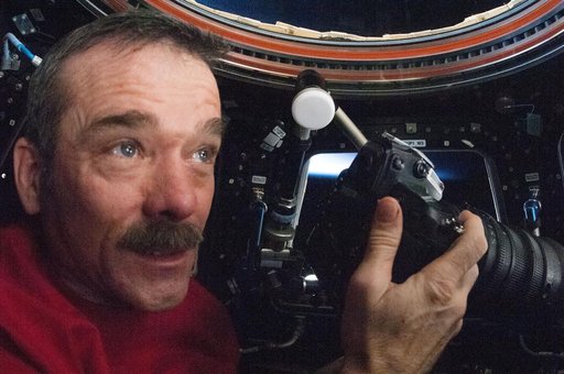 Hadfield uses still camera in the Cupola Module