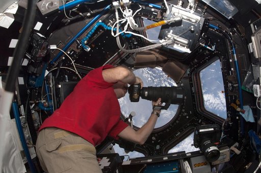 Hadfield uses digital camera in the Cupola Module