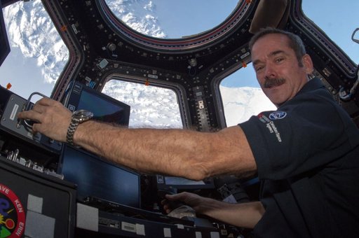 Hadfield works robotic controls in the Cupola Module