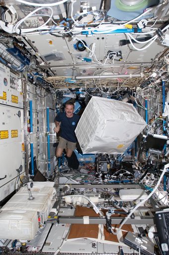 Hadfield moves a stowage container