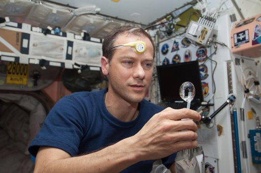 Marshburn squeezes a water bubble out of his beverage container