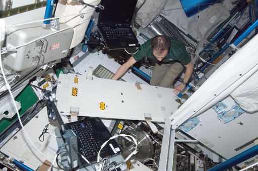 Marshburn removes and replaces the WHC pre-treat tank during in-flight maintenance