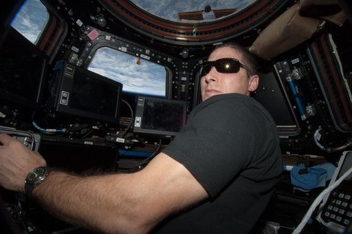 Hopkins at Robotic controls in the Cupola Module
