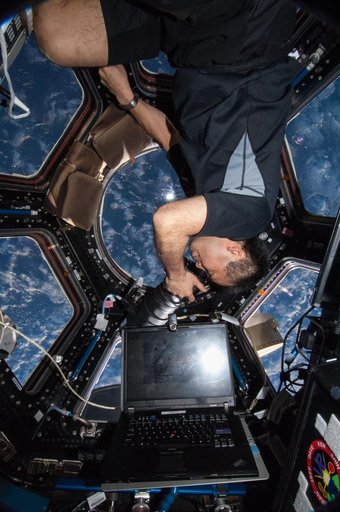 Wakata using still camera in the Cupola Module
