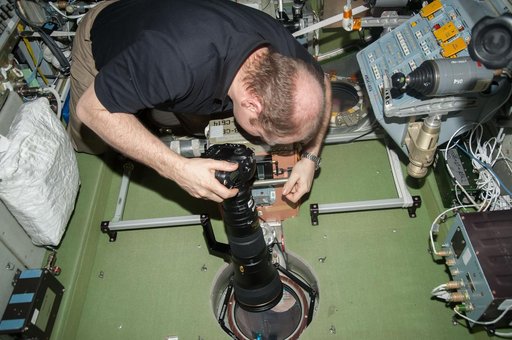 Kotov holds 400mm camera lens in the SM