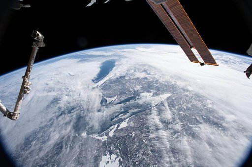 Lake Superior and Lake Michigan surrounded by the cloudy and frozen terrain of the North American continent.