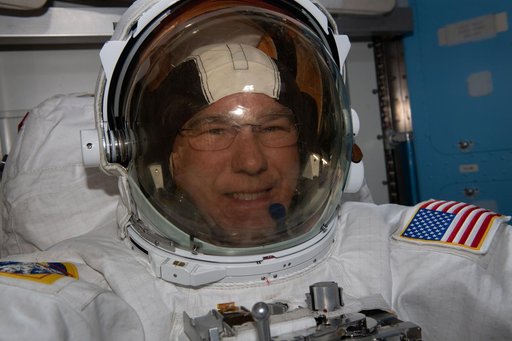 Astronaut Stephen Bowen tries on his spacesuit ahead of a spacewalk
