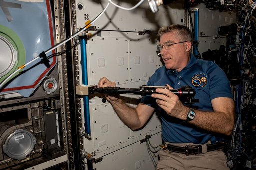 Astronaut Stephen Bowen installs student-made hardware