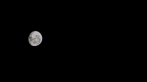 An illuminated waning gibbous moon