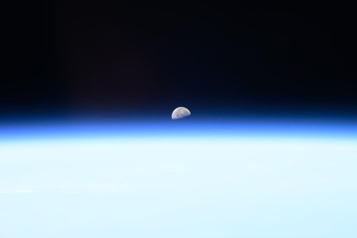 The third quarter Moon rises above Earth