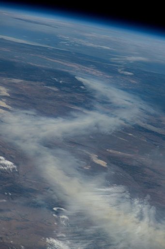 A wildfire in Canada and its smoke spreading in the atmosphere
