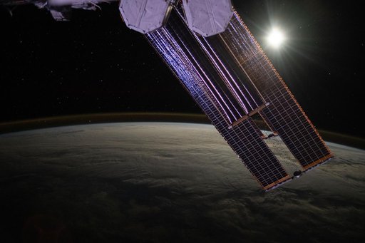 The Moon illuminates a cloud-covered Pacific Ocean