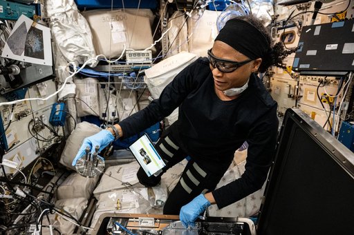 NASA astronaut Jeanette Epps configures the Metal 3D printer
