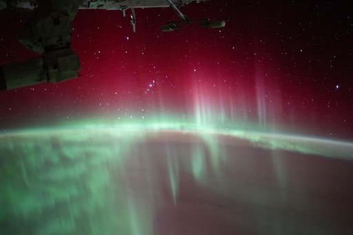 Stars glitter above aurora in Earth's atmosphere