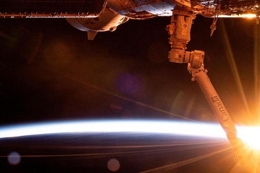 The first rays of an orbital sunrise breakthrough illuminating Earth's atmosphere