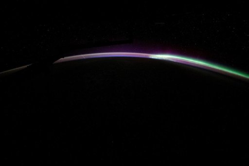 The aurora australis blends with Earth's atmospheric glow