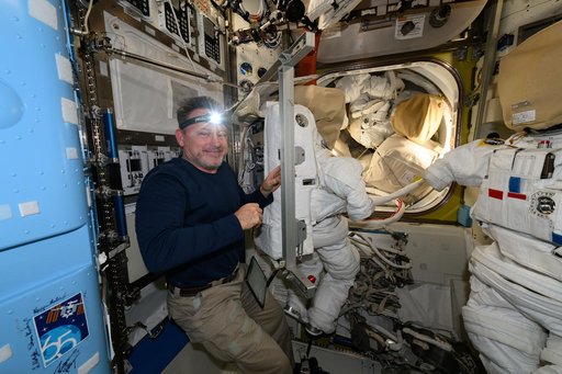 Astronaut Butch Wilmore performs spacesuit maintenance