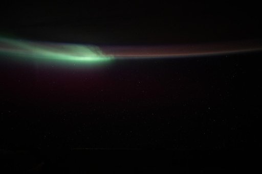 An aurora folds through Earth's atmosphere