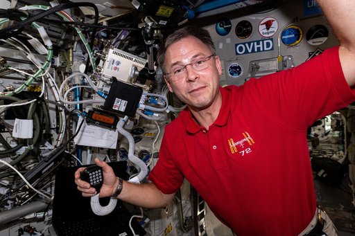 Astronaut Nick Hague calls down to students on a ham radio