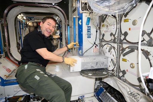 Astronaut Mike Barratt stows research samples in a science freezer