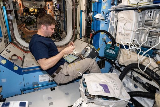 Astronaut Matthew Dominick works on ventilation maintenance