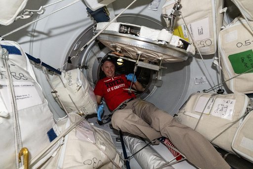 Astronaut Nick Hague in the vestibule between the space station and the Dragon cargo spacecraft