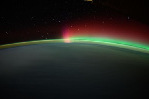 Streaks of city lights, star trails, an aurora, and Earth's atmospheric glow