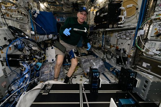 Astronaut Don Pettit works on weekend housekeeping duties