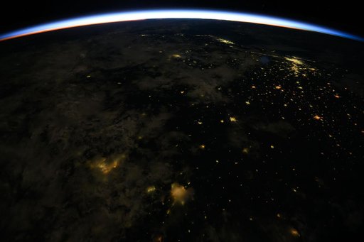 An orbital sunrise crowns Earth's horizon