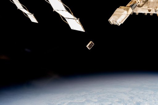 A CubeSat is ejected into Earth orbit from a small satellite orbital deployer