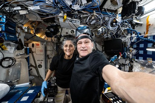 Astronauts Suni Williams and Don Pettit pose for a selfie-portrait