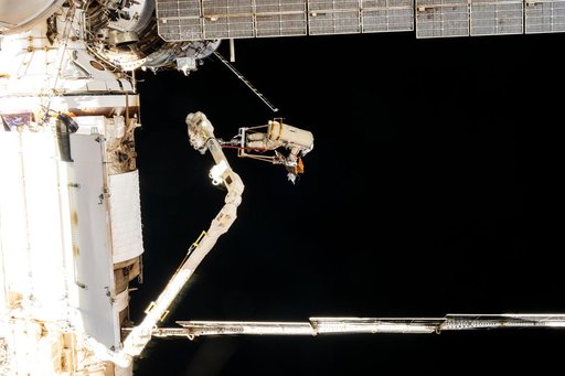 Roscosmos cosmonaut Alexey Ovchinin rides the European robotic arm
