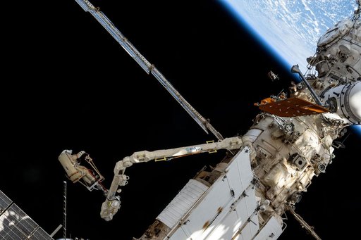 Roscosmos cosmonaut Alexey Ovchinin rides the European robotic arm
