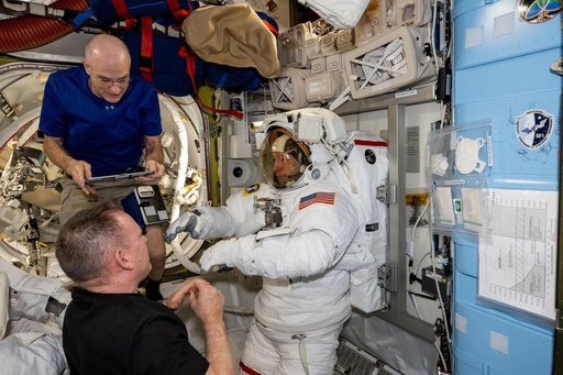 NASA astronauts evaluate a spacesuit